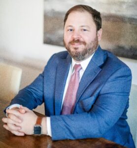 Picture of Stephen Martin Sitting at a Desk